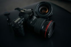 black-canon-dslr-camera-beside-camera-lens.jpg black Canon DSLR camera beside camera lens
